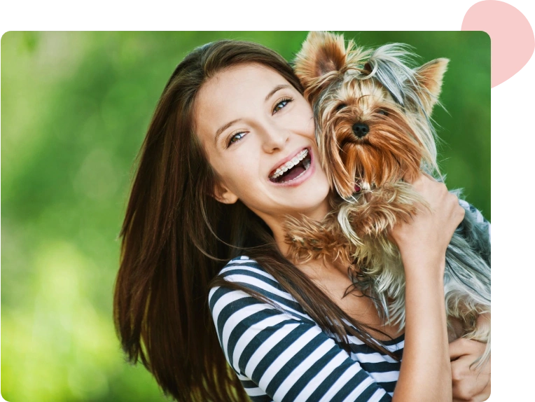 A woman holding her dog in the air