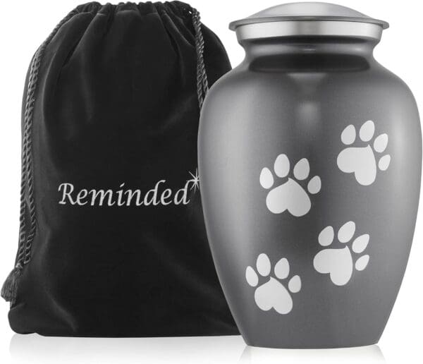 A paw print urn with a bag and pouch